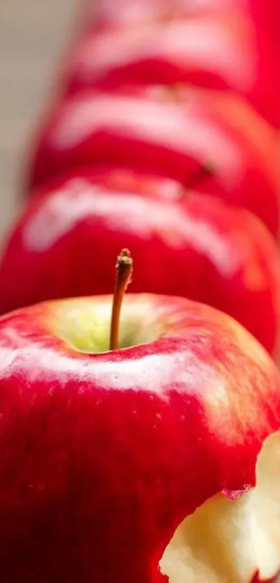 Close-up of red apples with a bite taken mobile wallpaper.