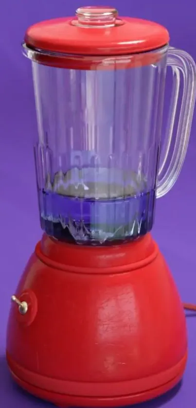 Red blender on a vibrant purple background, stylish and modern.