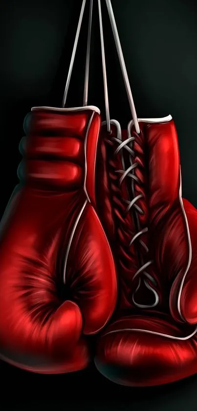 Vibrant red boxing gloves hanging on a dark background.