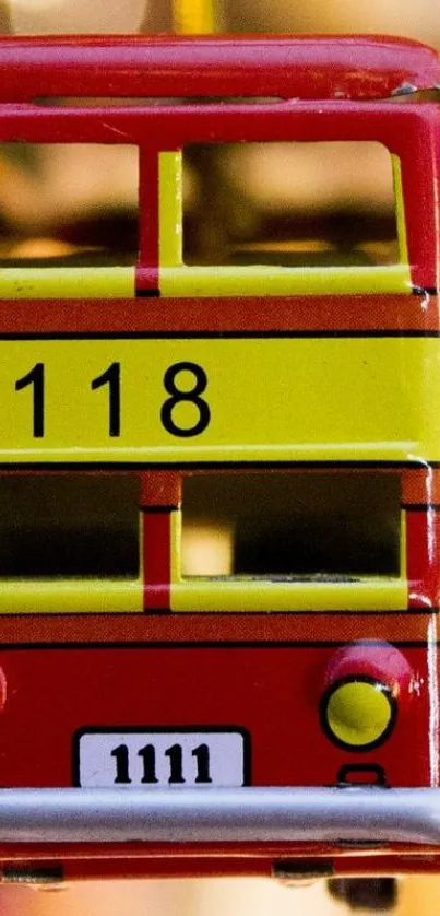 Front view of a red toy bus with yellow stripes and the number 118.