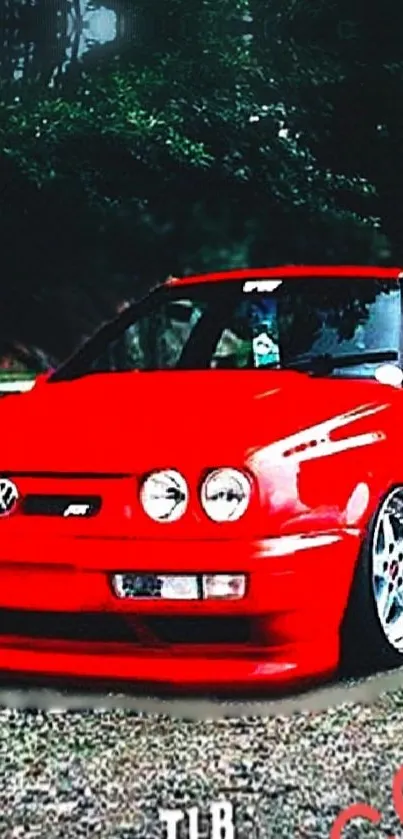 Vibrant red car against a lush forest backdrop.