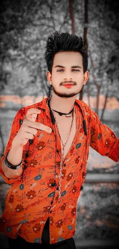 Man in vibrant red floral shirt with artistic background.