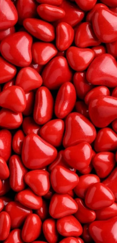 Heart-shaped red stones forming a vibrant wallpaper.