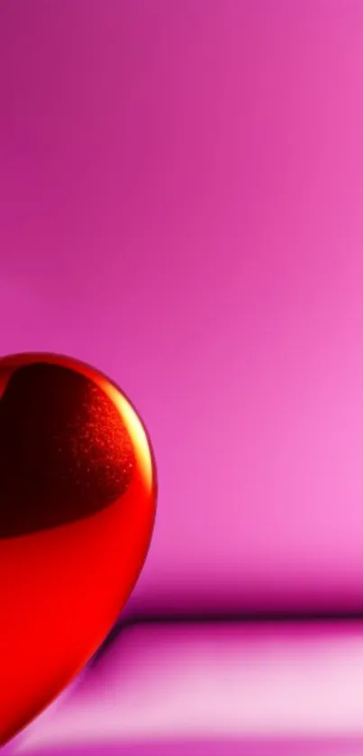 Vibrant red heart on pink background wallpaper.