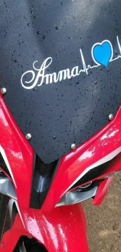 Bold red motorcycle with raindrops and heart graphic.