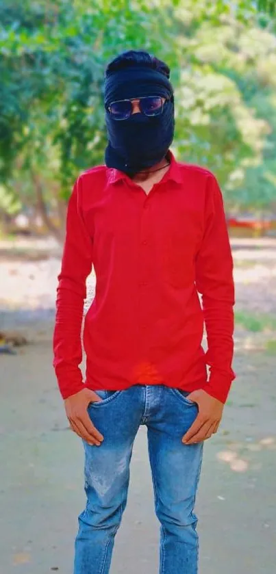 Stylish person in red shirt outdoors, vibrant background.