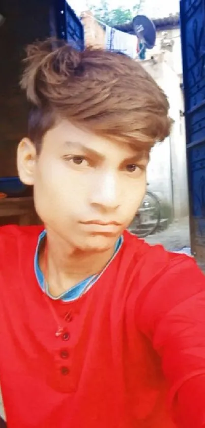 Young man in red shirt with rustic background.