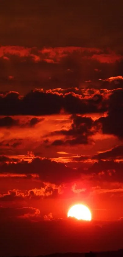 Vibrant red sunset with dramatic clouds filling the sky.