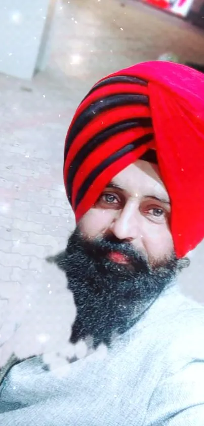 Man wearing a red turban in an outdoor setting, vibrant Sikh portrait.