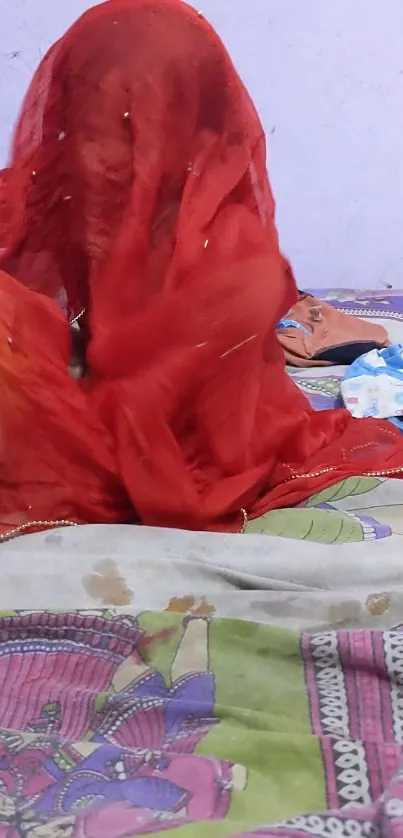 Vibrant red veil on a colorful bedspread.