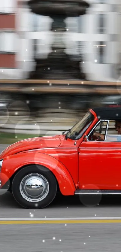 Red vintage convertible car driving through city streets.