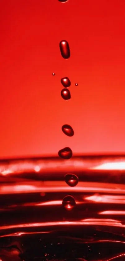 Red liquid drops splash on wallpaper background.