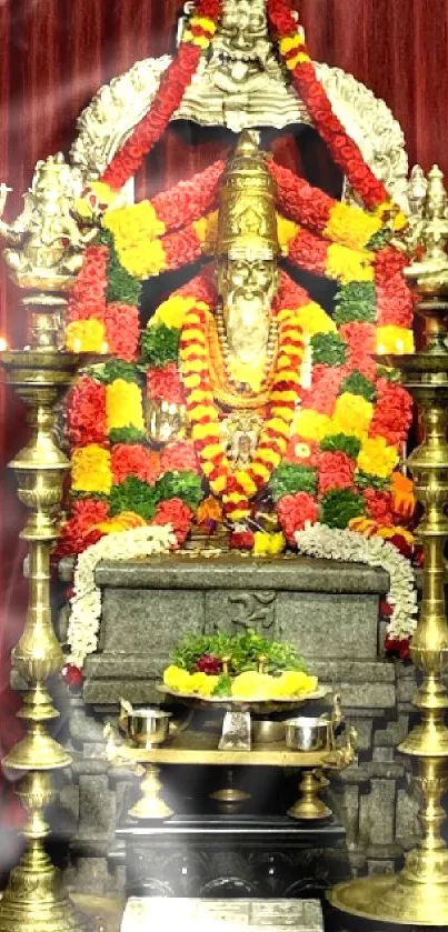 Vibrant temple shrine with colorful floral decor and spiritual idols.