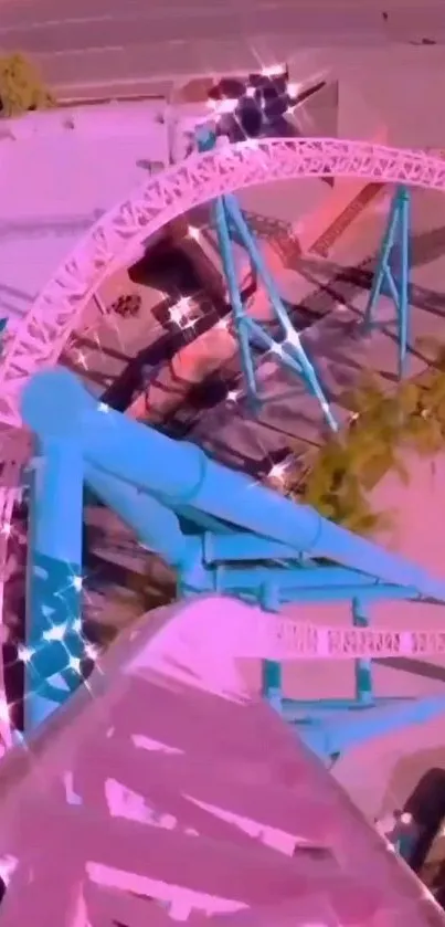 Aerial view of pink and blue roller coaster in amusement park.