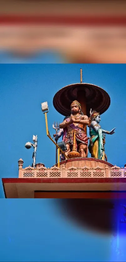 Colorful Indian rooftop sculpture against a clear blue sky.