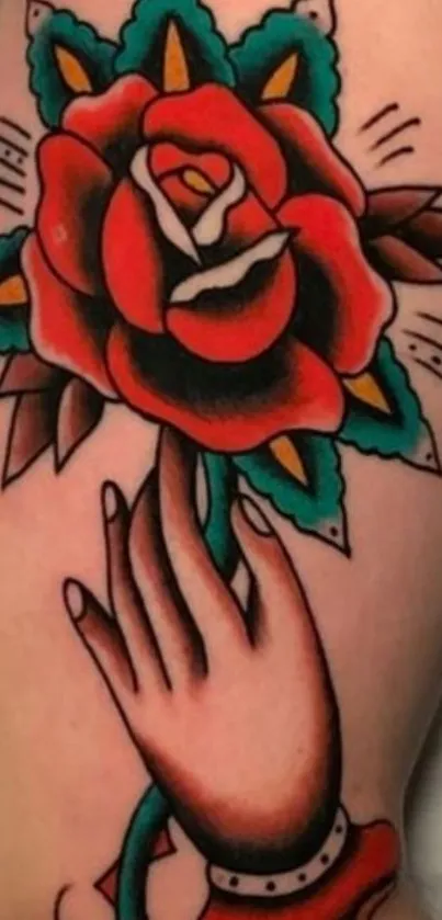 Vibrant rose tattoo with hand illustration.