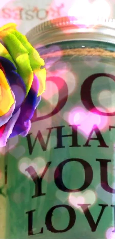 Vibrant roses in a vase next to a jar with motivational text.