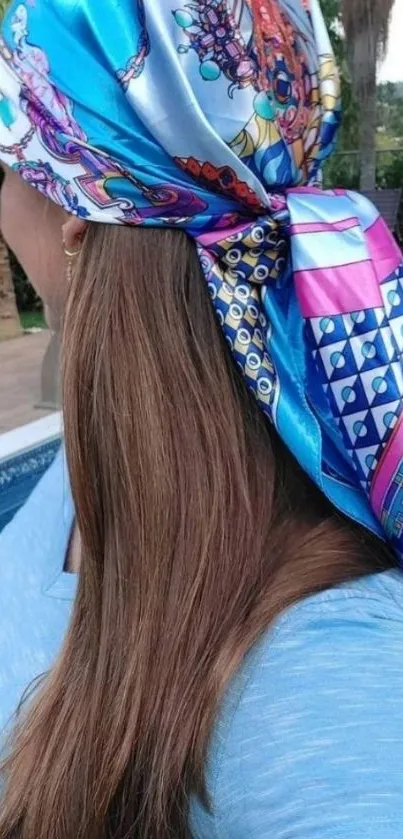 Vibrant scarf with blue patterns over hair.