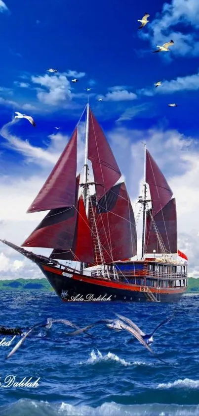 Majestic red sailboat on deep blue ocean with vibrant sky and soaring birds.