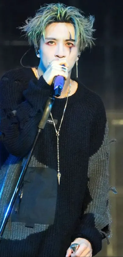 Singer passionately performing on stage in black attire.