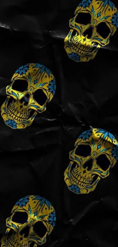 Vibrant yellow and blue skulls on dark wallpaper background.