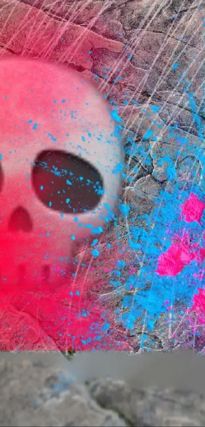 Vibrant skull art with pink and blue splashes on stone background.