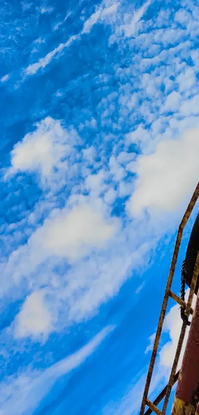 Vibrant mobile wallpaper with blue sky and building edge.