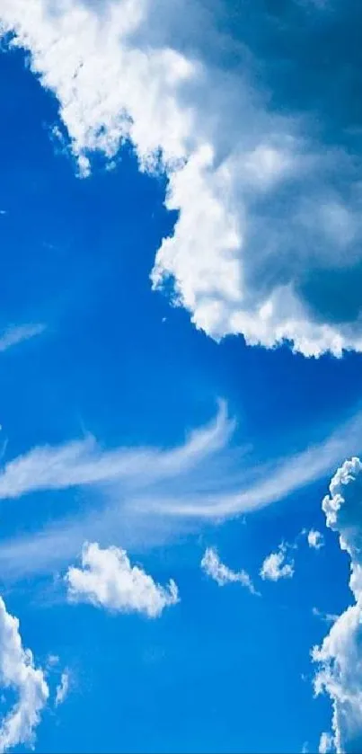 Vibrant blue sky with fluffy clouds wallpaper for mobile.