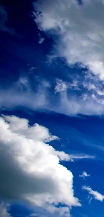 Deep blue sky with fluffy white clouds.