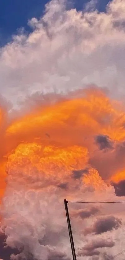 Fiery orange clouds against a blue sky, creating a dramatic mobile wallpaper.