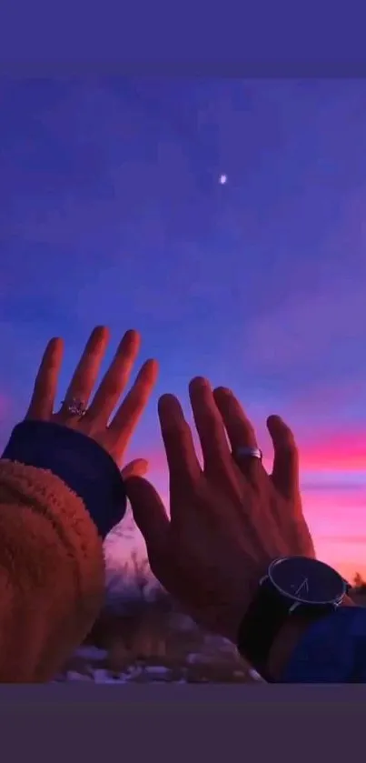 Hands reaching towards a vibrant purple and pink sunset sky with a visible star.