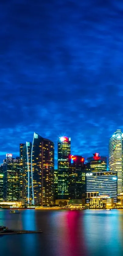 Nighttime city skyline with vibrant lights reflecting on water.