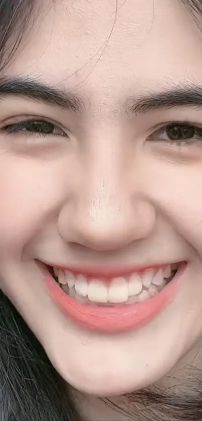 Close-up of a smiling face with light pink tones.