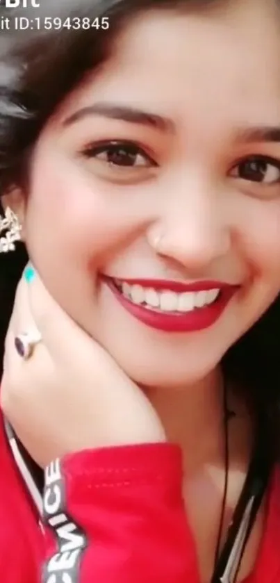 Smiling woman in red outfit with stylish earrings and vibrant expression.