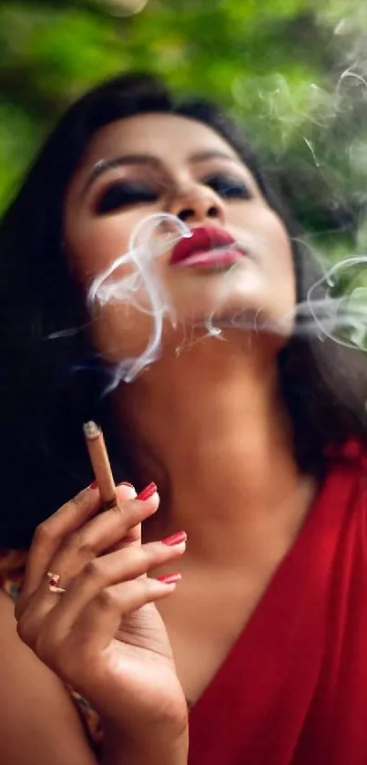 Woman in red exhaling smoke, lush green backdrop.