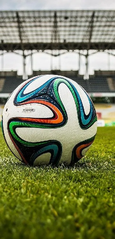 Vibrant soccer ball on grass in a stadium, perfect for sports lovers.