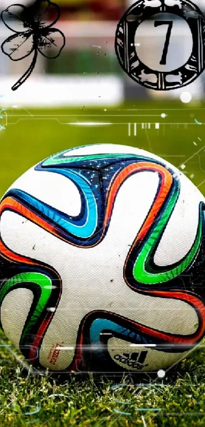 Colorful soccer ball on a green field with stadium backdrop.