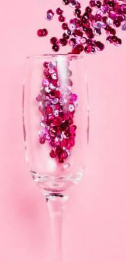 Glass with cascading pink sequins on a pink background.