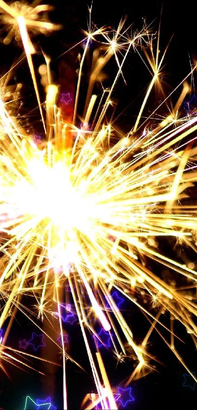 Close-up of a bright sparkler bursting with golden light on a dark background.