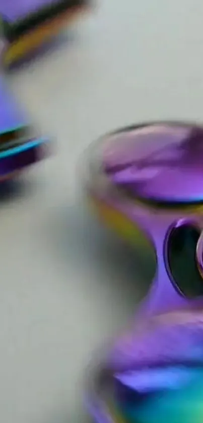 Close-up of colorful metallic spinner with vibrant purple and gold tones.