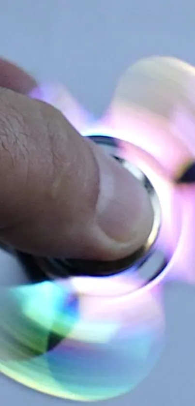 Colorful spinner in motion against a light gray background.