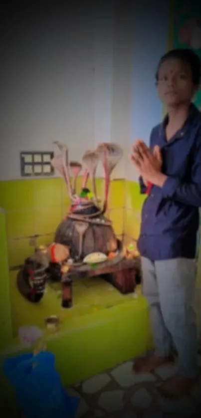 Person in traditional attire during a spiritual ritual.