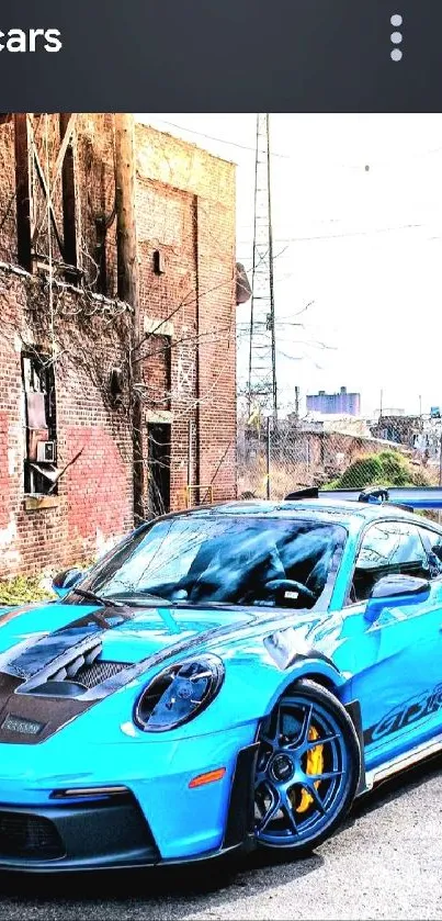 Blue sports car in an urban setting with rustic background.