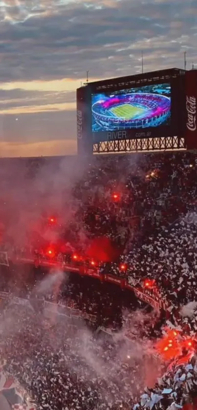 A lively stadium scene with lights and fans under an evening sky.