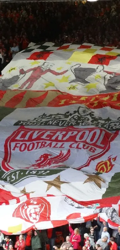 Crowded stadium with large Liverpool FC banner.