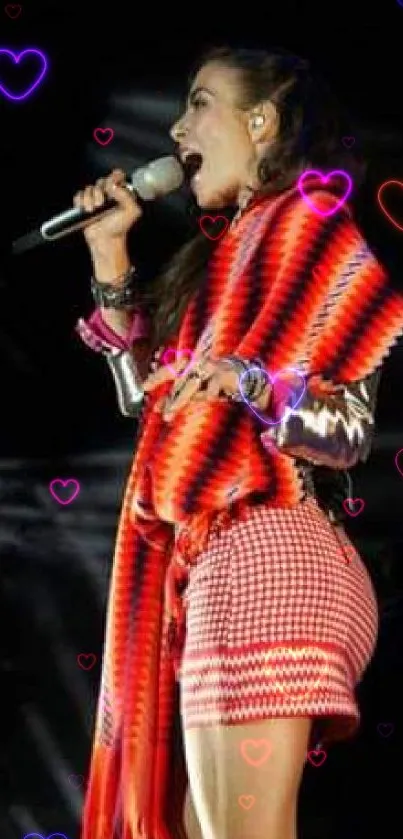 Singer in colorful attire performing passionately on stage with bright lights.