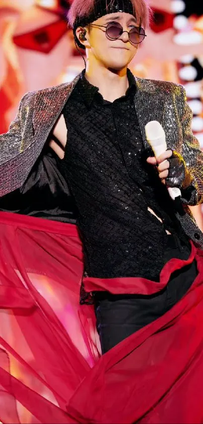 Performer in vibrant outfit with red accents on stage.