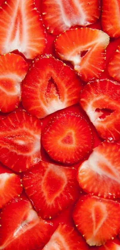 Close up of sliced strawberries creating a vibrant red wallpaper.