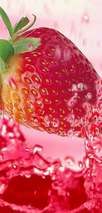 Juicy strawberry splashing in pink water wallpaper.