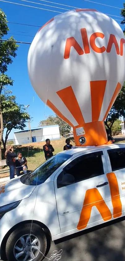 A unique car with balloon decor on a sunny street, vibrant and eye-catching.